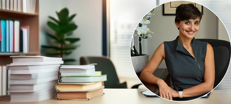 Image of Dr. Irene Piryatinsky in a circular image bubble with a psychologist's office filled with books and assessments as background